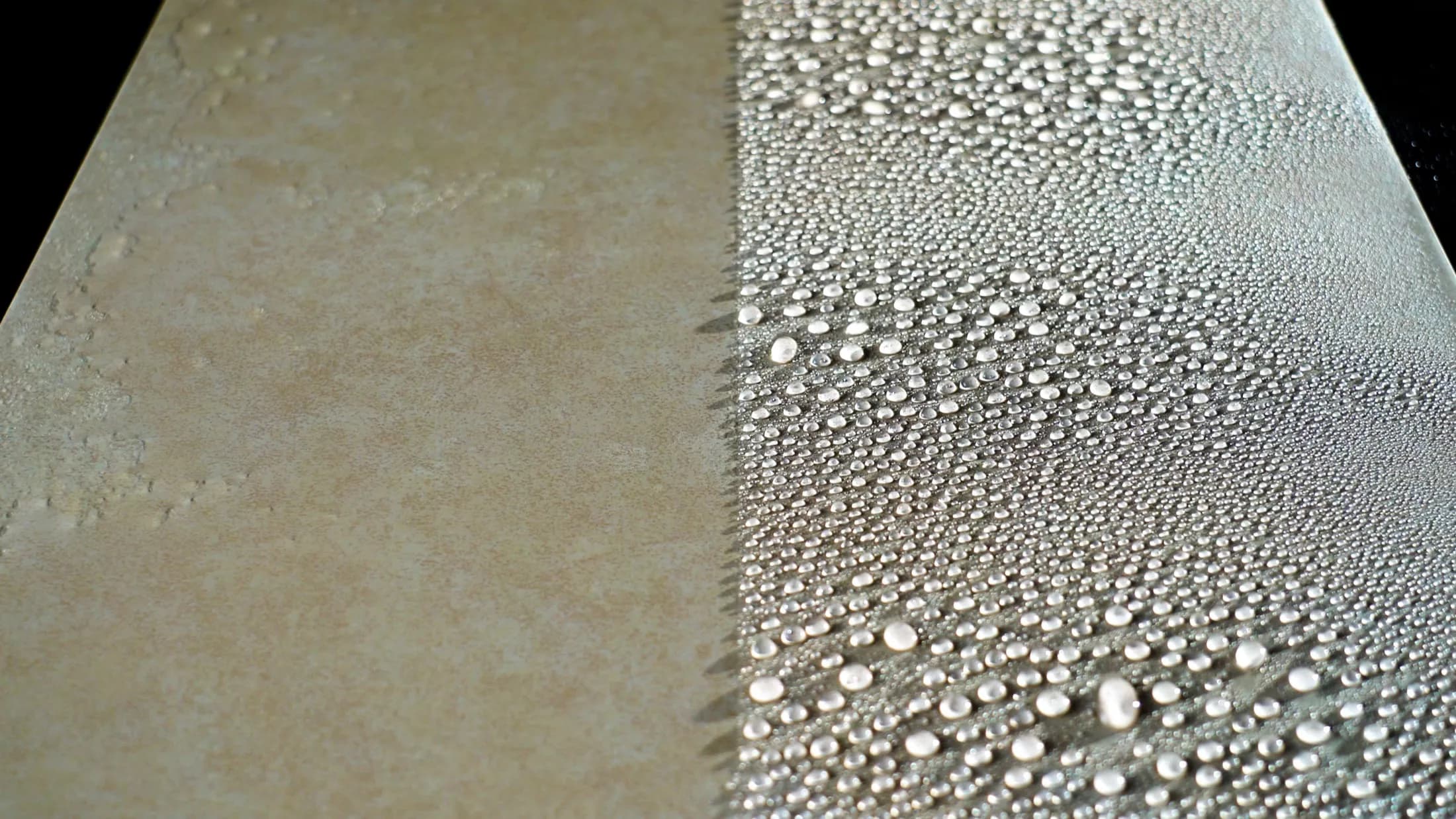 One surface under water spray: the untreated left half soaks it up, the coated right half beads it